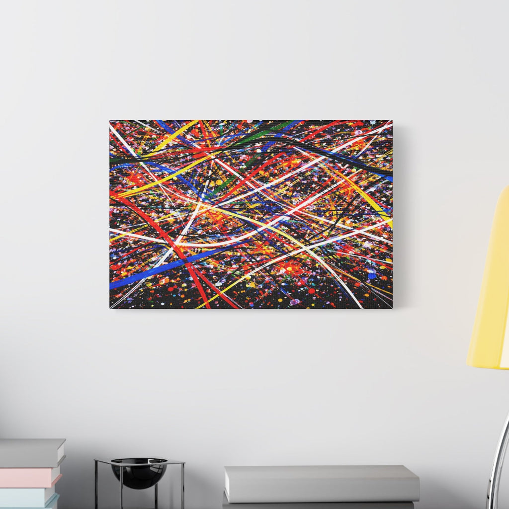 Abstract colorful painting on a wall above a shelf with books and a lamp.
