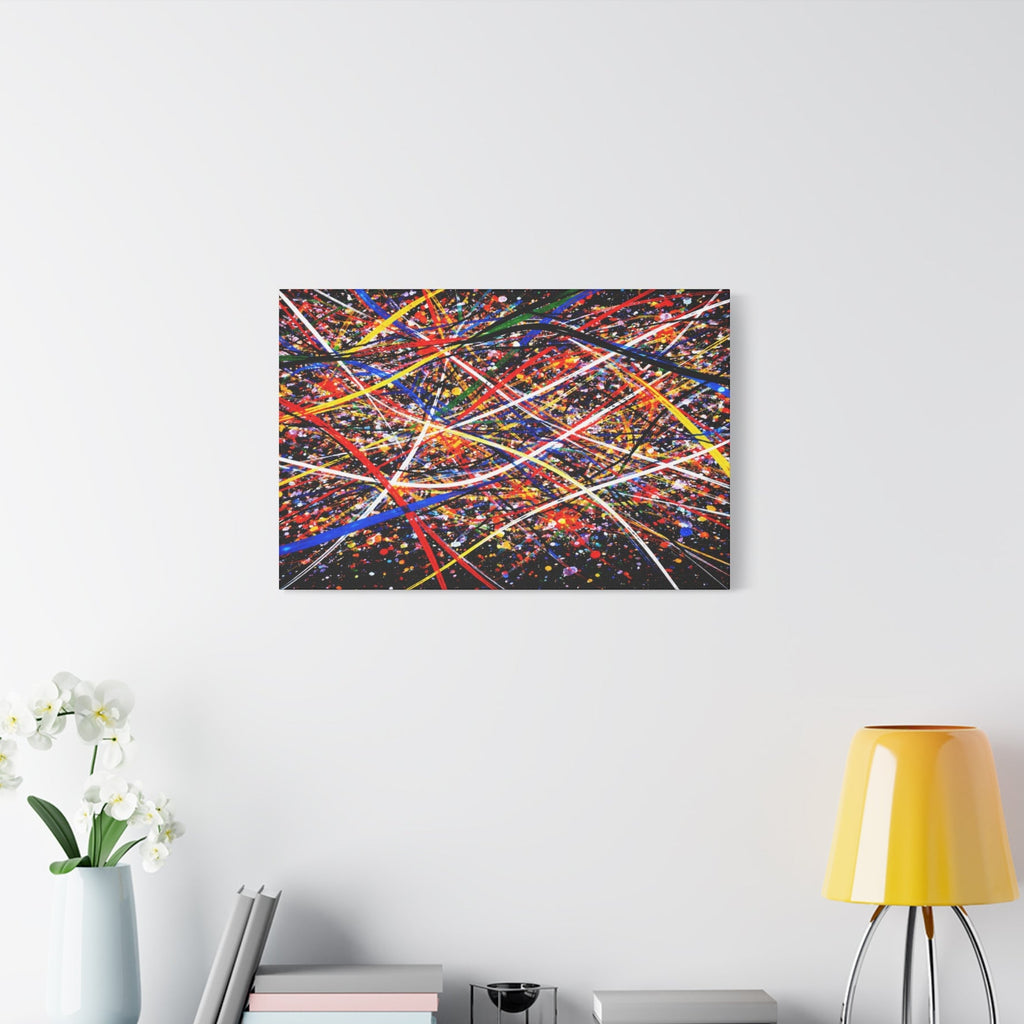 Abstract colorful painting on a wall above a white cabinet with decorative items.