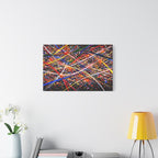 Abstract colorful painting on a wall above a white cabinet with decorative items.