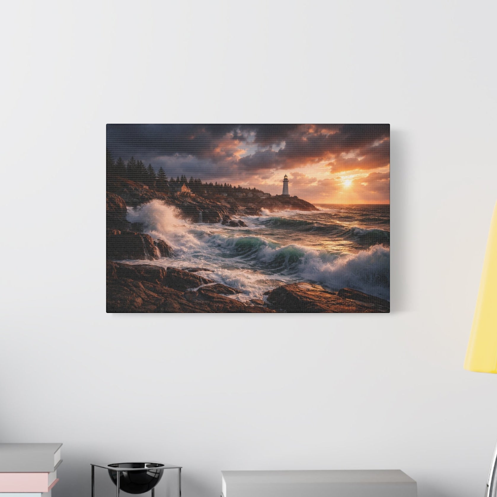 Canvas print of a lighthouse scene with crashing waves on a wall above a desk.