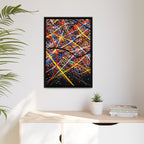 Abstract painting with colorful strokes in a black frame on a white wall above a wooden desk.