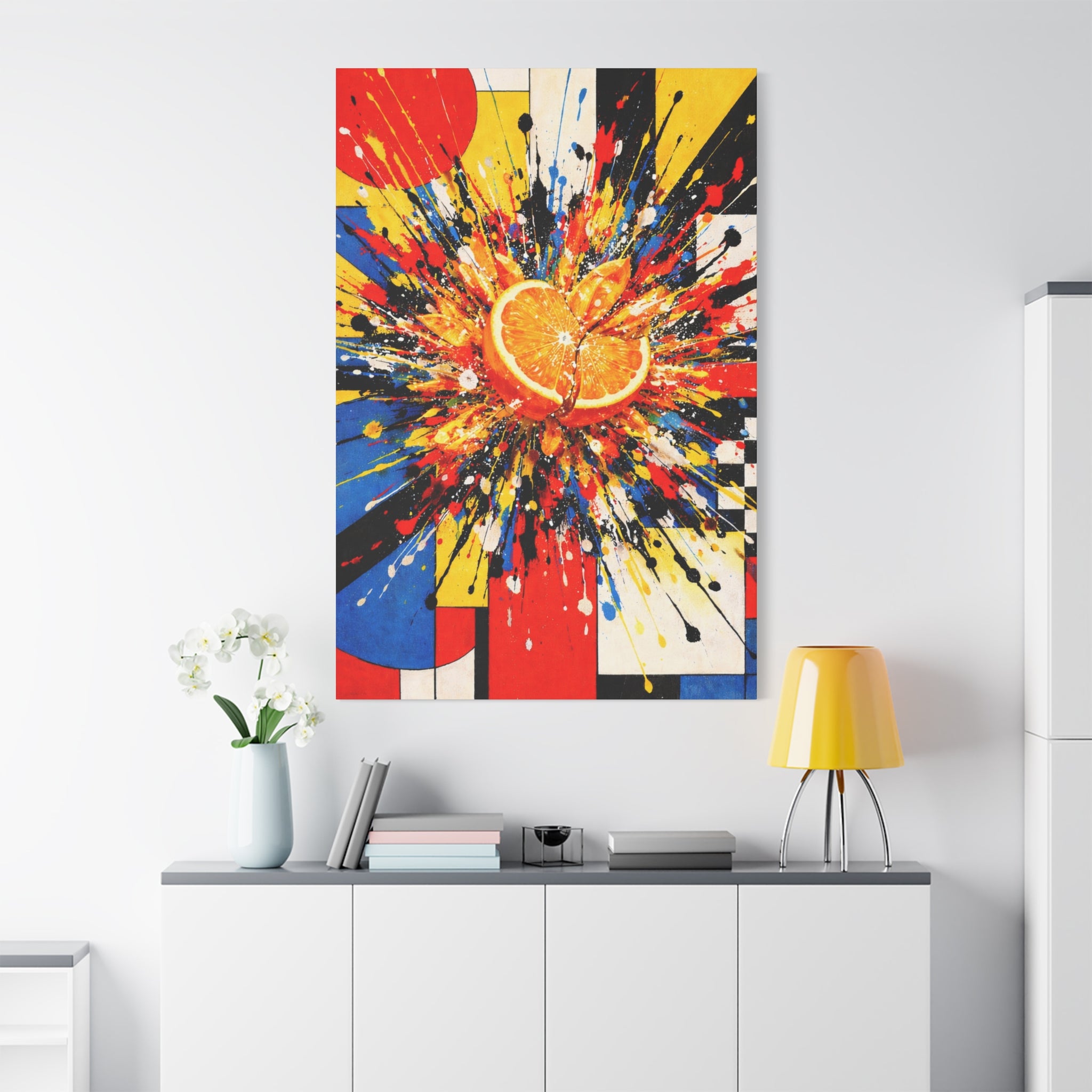 Colorful abstract painting of an orange on a white wall above a white cabinet.