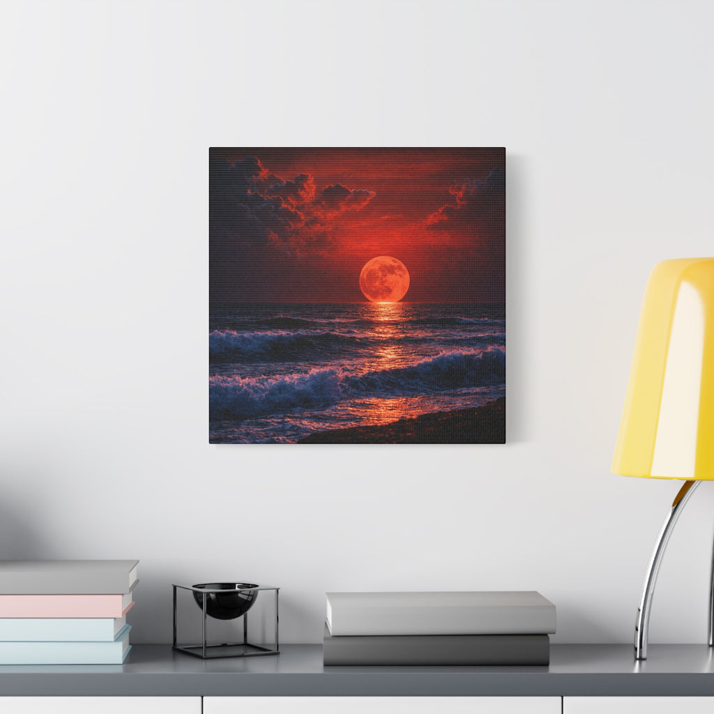 Framed artwork of a sunset over water with a red moon on a white wall above a desk.