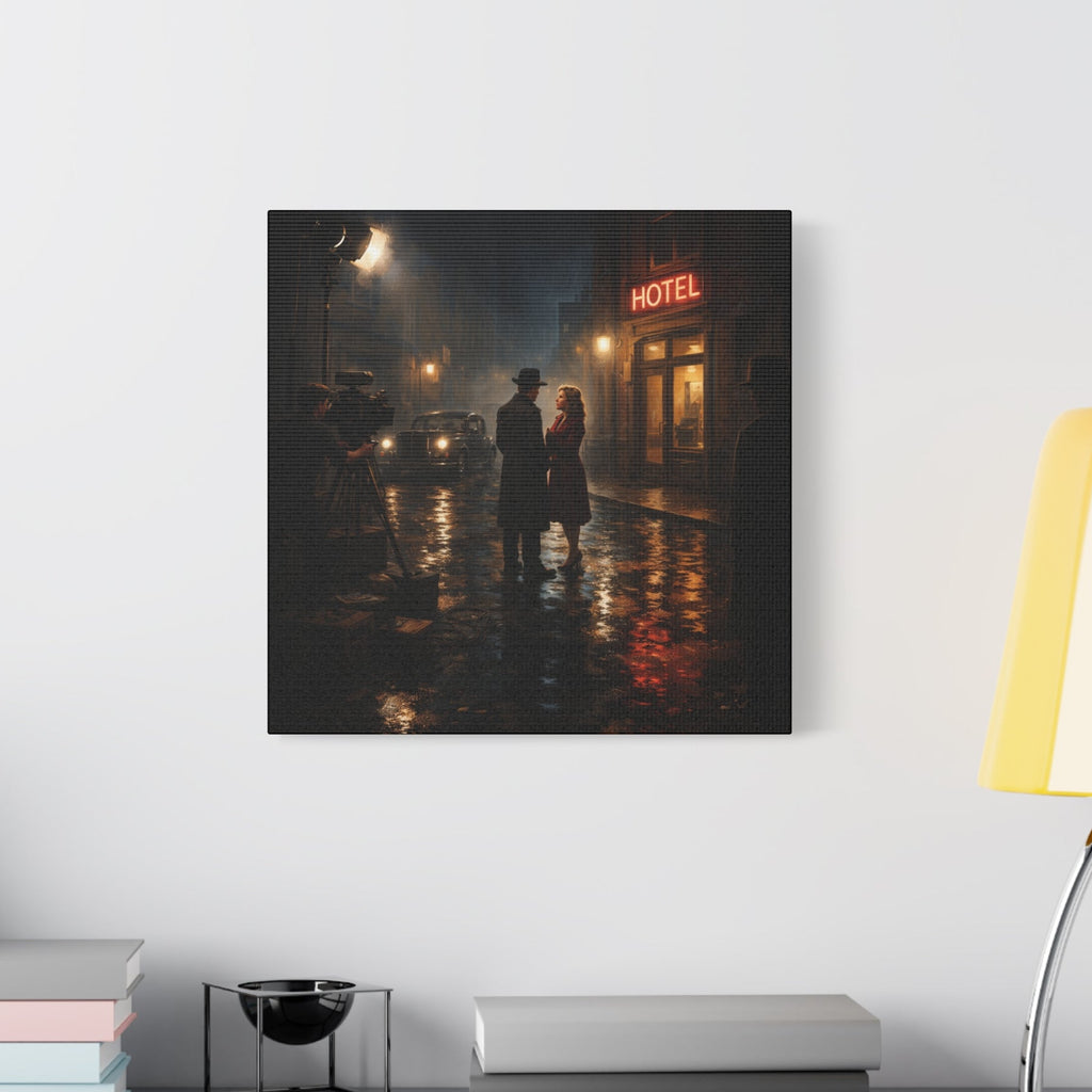 Framed artwork of a couple on a rainy street with a hotel sign, displayed on a wall above a desk.