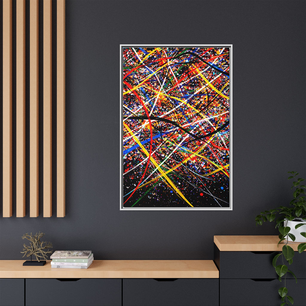 Framed abstract artwork with colorful lines on a dark wall.